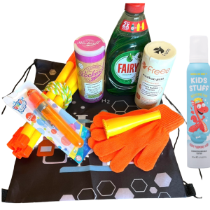 The Bubbleology Science Kit displayed on a surface. The kit includes Fairy Liquid, bicarbonate of soda, xanthan gum, a bubble blower, orange gloves, yellow bubble wands, a tri-string rope wand, Bouncing foam soap and a black Science2Life drawstring bag with a chemistry-themed design.