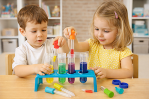 Children using a Science2Life test tube set to mix coloured liquids with droppers during a hands-on science activity