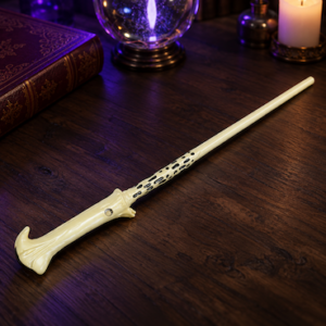 Voldemort-style cream wand with a hooked, bone-like handle and black detailing, displayed on a dark wooden table.